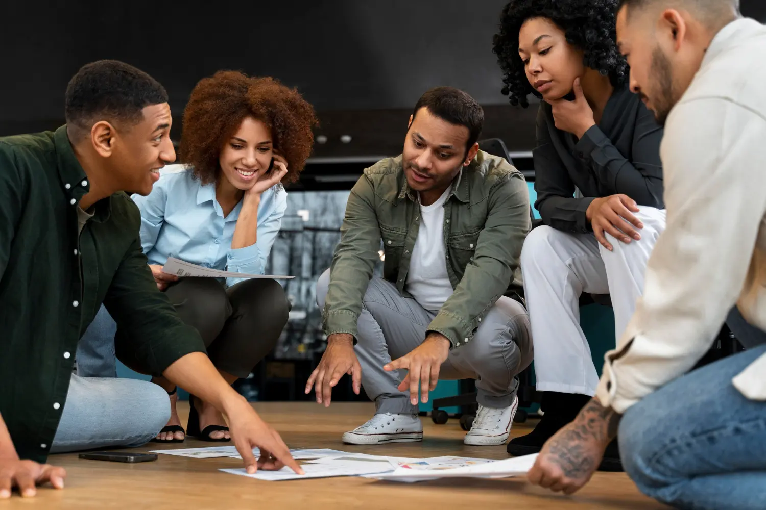 People studying a document on the floor